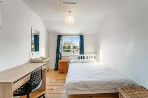 a bedroom with a bed and a sink and a window at No 4 Georgian Shared House - By Clifton Short Lets in Bristol