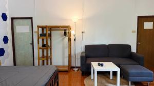 a living room with a couch and a table at Zen Forest in Ko Phangan