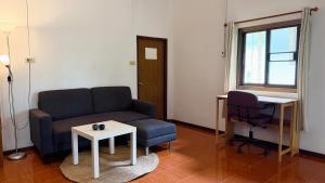 a living room with a couch and a table at Zen Forest in Ko Phangan