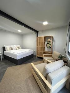 a bedroom with a large bed and a couch at MühlengasseONE in Lenzing