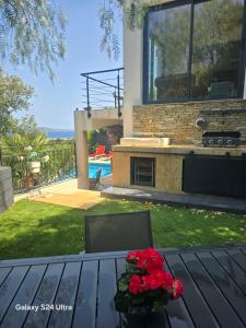 a table with a vase of flowers on it at La lézarde in Cavalaire-sur-Mer +5 photos