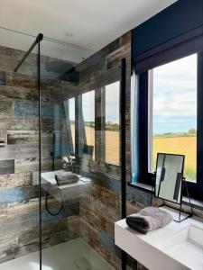 a bathroom with two sinks and a glass shower at Uno Carbis Bay - Boutique Luxury Accommodation in Carbis Bay +37 photos
