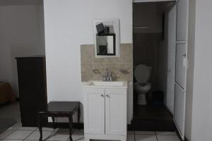 a bathroom with a white sink and a toilet at Hotel Dulce Morelia in Morelia +47 photos