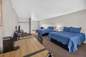 a hotel room with two beds and a flat screen tv at Little River Marina in Cedar Bluff