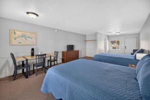 a hotel room with two beds and a table and a desk at Little River Marina in Cedar Bluff