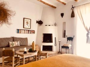a living room with a couch and a fireplace at Dar Alya Essaouira Maison et table d'hôtes in Ghazoua
