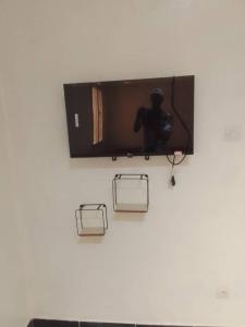 a television on a wall with a camera on it at Chez ABDOUL in Rufisque