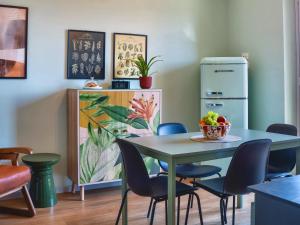 a dining room with a table and chairs at My Tuscany Green Apartment in San Quirico dʼOrcia