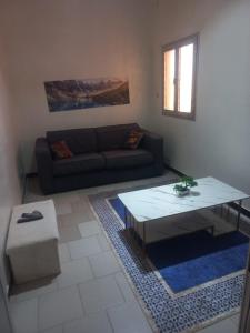 a living room with a couch and a coffee table at Chez ABDOUL in Rufisque