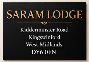 a black sign with the words sanam lodge and istg roadssmith istg at Saram Lodge Dudley in Dudley