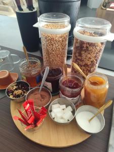 a wooden plate topped with different types of food at Villa Oasis Bollène in Bollène