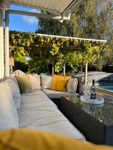 a patio with a white couch and a table at Villa Circus in Halmstad