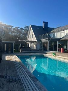 a large swimming pool in front of a house at Villa Circus in Halmstad
