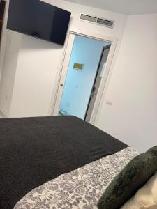 a bedroom with a bed and a door with a window at Cura Marina 2 in Playa del Cura +23 photos