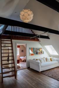 a living room with a white couch and a staircase at Villa Circus in Halmstad +51 photos