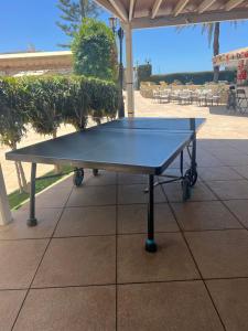 a ping pong table sitting on a patio at Cura Marina 2 in Playa del Cura
