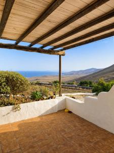 an outdoor patio with a view of the mountains at Tabaiba Suites Lanzarote - Macaronesia Homes in La Asomada
