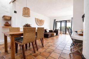 a kitchen and living room with a table and chairs at Tabaiba Suites Lanzarote - Macaronesia Homes in La Asomada