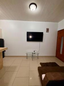 a living room with a flat screen tv on the wall at House Puerto Viejo in Puerto Viejo
