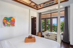 a bedroom with a bed and a large window at NB Villa Lilawadee in Chaweng Noi Beach +28 photos