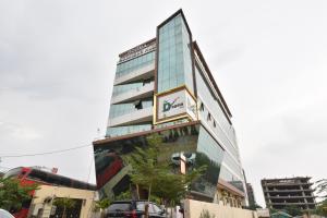 a building with a sign on the side of it at Luxora Suites in Jaipur