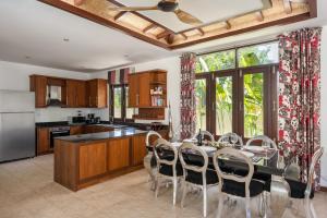 a kitchen with a table and chairs in a kitchen at NB Villa Lilawadee in Chaweng Noi Beach