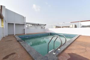 a swimming pool on the roof of a building at Luxora Suites in Jaipur