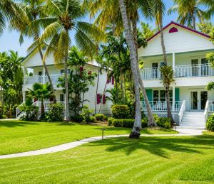 a white house with palm trees in front of it at Cheeca Lodge & Spa in Islamorada