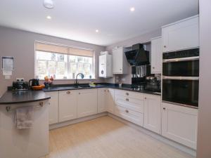 a kitchen with white cabinets and black counter tops at 19 Lion Street in Hereford