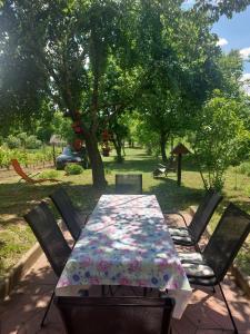 a table and chairs with a table cloth on it at Oaza Slankamen in Slankamenački Vinogradi