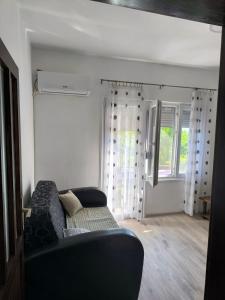 a living room with a couch and a window at Oaza Slankamen in Slankamenački Vinogradi +7 photos