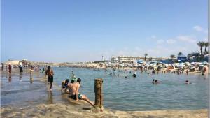 a group of people in the water at a beach at Blue Horizon Mansouriah in Mohammedia