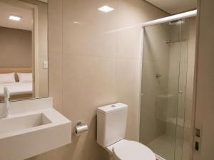 a bathroom with a shower and a toilet and a sink at Smart Hotel Aeroporto by Bsb Inn in Brasília