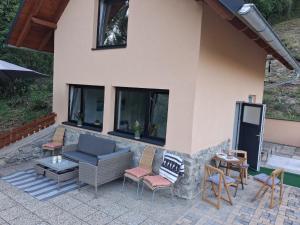 a patio of a house with chairs and a couch at Eichberghaus in Aue