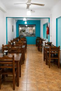 a dining room with wooden tables and chairs at Hotel Diamante in Resistencia