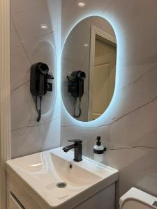 a bathroom with a sink and a mirror at K41House in Almaty