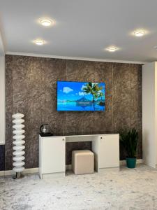 a living room with a tv on a wall at K41House in Almaty