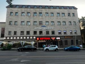 a large building with cars parked in front of it at K41House in Almaty