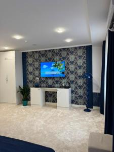 a living room with a tv on a wall at K41House in Almaty +12 photos