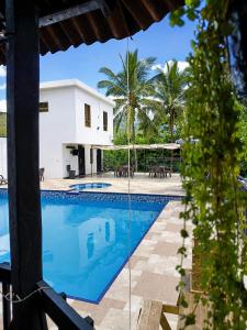 a swimming pool in front of a villa at Naru CasaBlanca in Utica