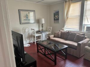 a living room with a couch and a coffee table at The Traveler Suite C1 in Hartford