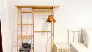 a ladder shelf in a bedroom next to a bed at Zen Hideaway - Cute Modern Thai Home in Ko Phangan