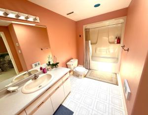 a bathroom with a sink and a toilet at The Shearwater House - Panoramic Ocean View Suites in Nanaimo