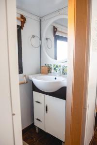 a bathroom with a sink and a mirror at Carmela Suites Cabo Polonio in Cabo Polonio