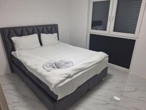 a bed with a towel on it in a bedroom at Vila Gaia in Sarajevo