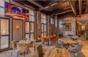 a restaurant with tables and chairs in a room at Mapungubwe apartment in Johannesburg