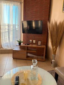 a living room with a tv and a coffee table at Mapungubwe apartment in Johannesburg