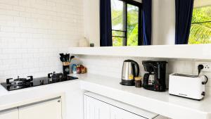 a kitchen counter with a coffee maker and a sink at Zen Nest in Ko Phangan