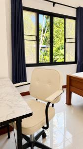 a room with a chair and a table and windows at Zen Nest in Ko Phangan +45 photos