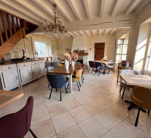 a large dining room with a table and chairs at Le Colombier de Hanches - Teritoria in Hanches
